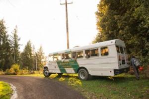 white bus parked next to dirt road